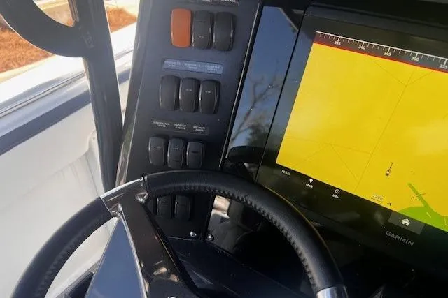 Slide: The Image of 2020 Blackfin 332 CC boat dashboard with Garmin navigation display and control panel. - 10