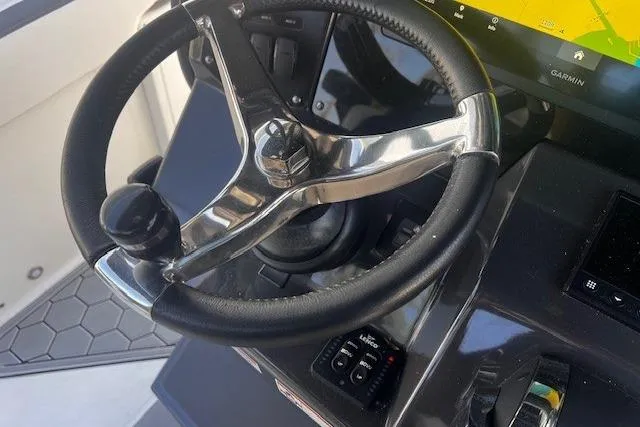 Slide: The Image of Steering wheel of a 2020 Blackfin 332 CC boat with navigation controls. - 11
