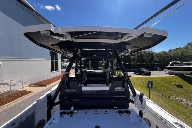 Slide: The Image of 2020 Blackfin 332 CC boat with sleek design and modern features, docked outdoors. - 15