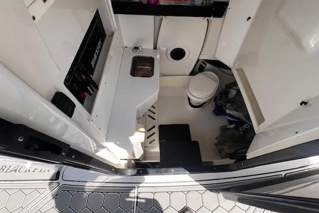 Slide: The Image of Interior view of 2020 Blackfin 332 CC boat cabin with sink and toilet. - 23