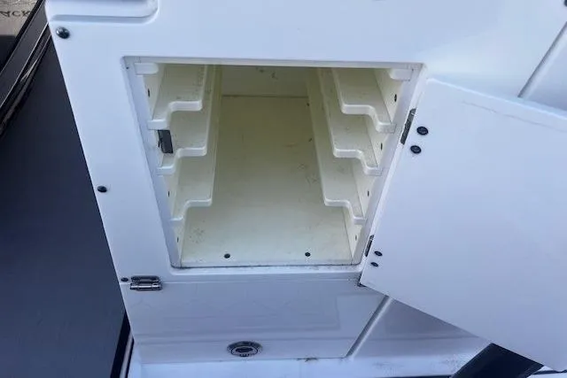 Slide: The Image of Open storage compartment on a 2020 Blackfin 332 CC boat, showcasing interior shelving. - 30