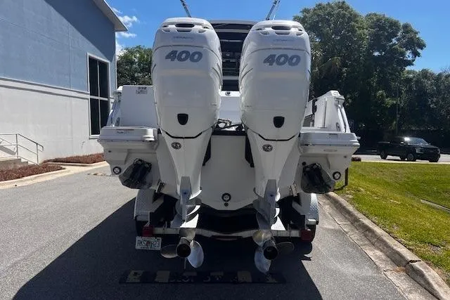 Slide: The Image of 2020 Blackfin 332 CC boat with twin 400 horsepower engines, parked outdoors. - 4