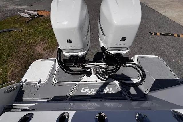 Slide: The Image of 2020 Blackfin 332 CC boat with dual Mercury outboard engines, docked on a sunny day. - 6