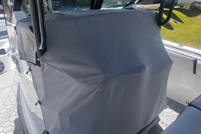 Slide: The Image of 2020 Blackfin 332 CC boat console covered with a protective gray cover. - 7