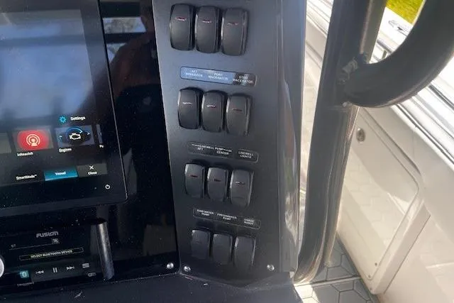 Slide: The Image of Control panel of a 2020 Blackfin 332 CC boat with switches and touchscreen display. - 9