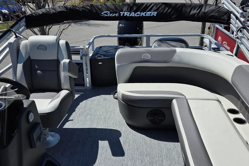 Slide: The Image of 2026 Sun Tracker Bass Buggy 18 DLX pontoon boat interior with seating and steering console. - 4