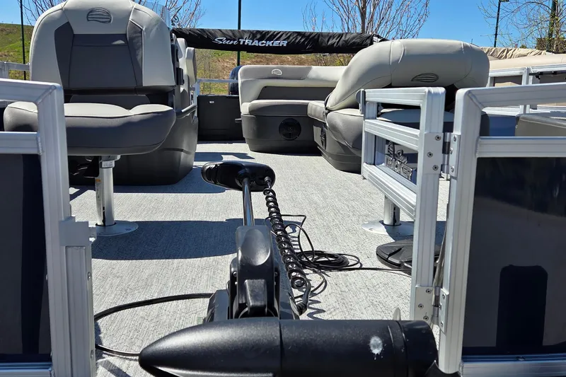Slide: The Image of Interior view of 2026 Sun Tracker Bass Buggy 18 DLX pontoon boat with seating and equipment. - 5