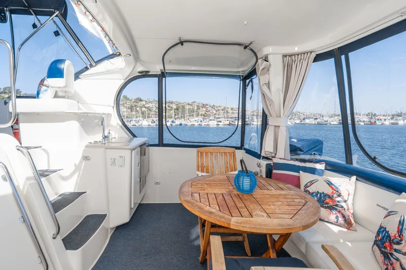 Slide: The Image of Interior of a 2004 Silverton 39 MY Diesel yacht with wooden table. - 13