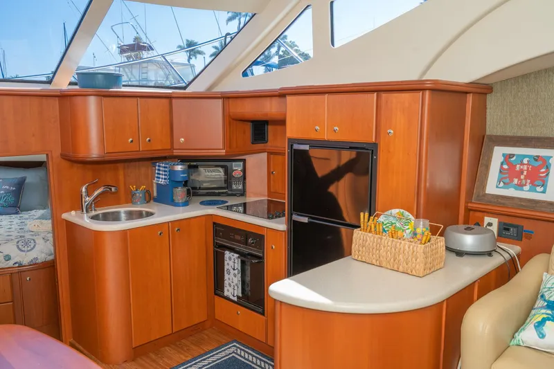 Slide: The Image of Interior of 2004 Silverton 39 MY Diesel yacht, featuring kitchen and living area. - 32