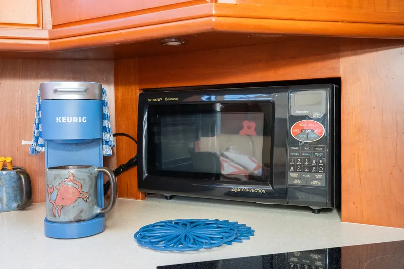 Slide: The Image of Kitchen counter with Keurig coffee maker and Sharp microwave on Silverton 39 MY Diesel 2004. - 35