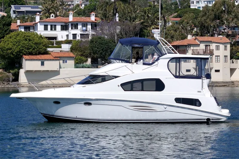 Slide: The Image of 2004 Silverton 39 MY Diesel yacht near coastal homes. - 4