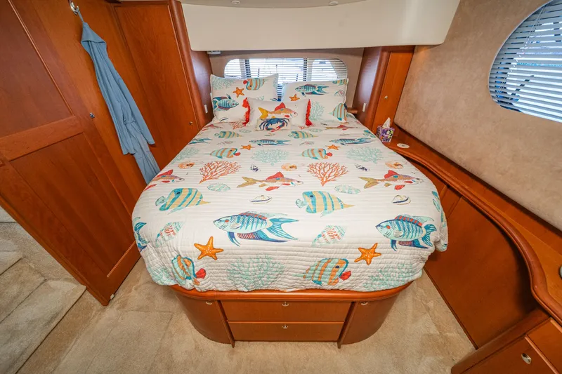 Slide: The Image of Bedroom in 2004 Silverton 39 MY Diesel with marine-themed bedding. - 43