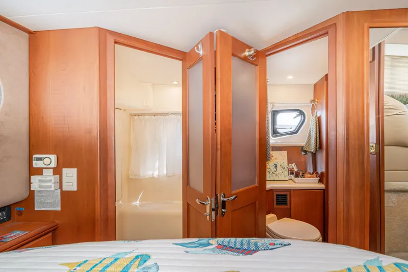Slide: The Image of Interior of 2004 Silverton 39 MY Diesel yacht with bathroom and wooden doors. - 44