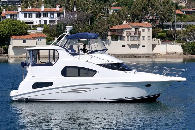 Slide: The Image of 2004 Silverton 39 MY Diesel yacht on calm water near villas. - 5