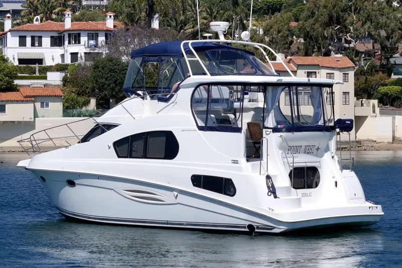Slide: The Image of 2004 Silverton 39 MY Diesel yacht on water near coastal homes. - 9