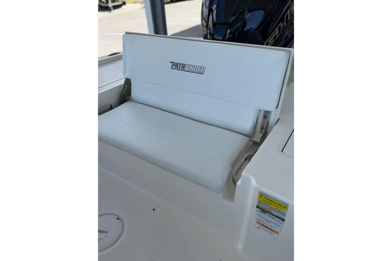 Slide: The Image of 2025 Pathfinder 2200 TRS boat seat with logo, showcasing sleek white design. - 13