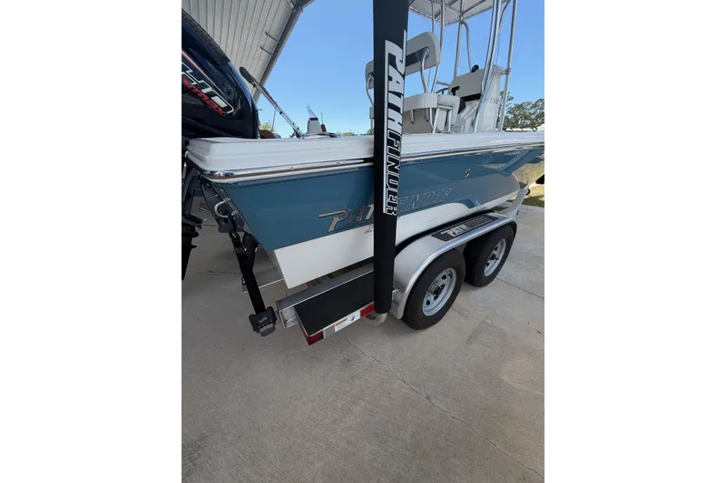 Slide: The Image of 2025 Pathfinder 2200 TRS boat on trailer, parked outdoors under a canopy. - 3