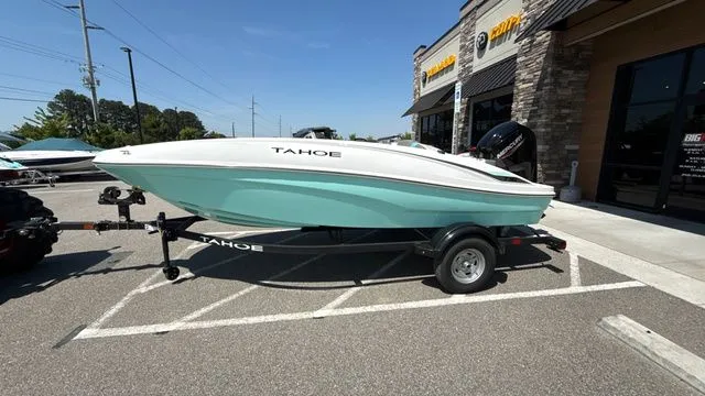 Slide: The Image of 2026 Tahoe T16 boat on trailer parked outside store. - 4