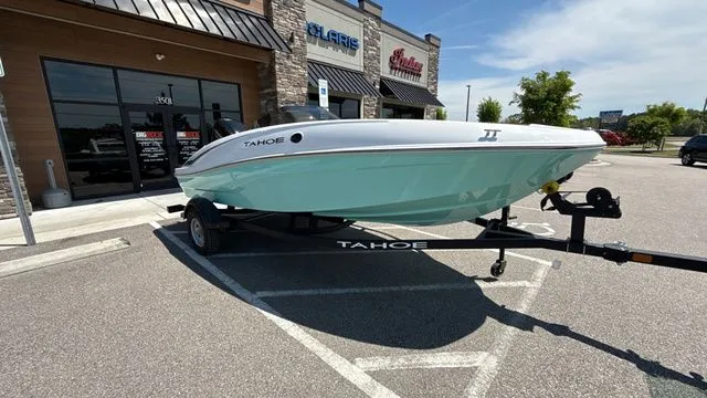 Slide: The Image of 2026 Tahoe T16 boat on trailer outside store. - 9