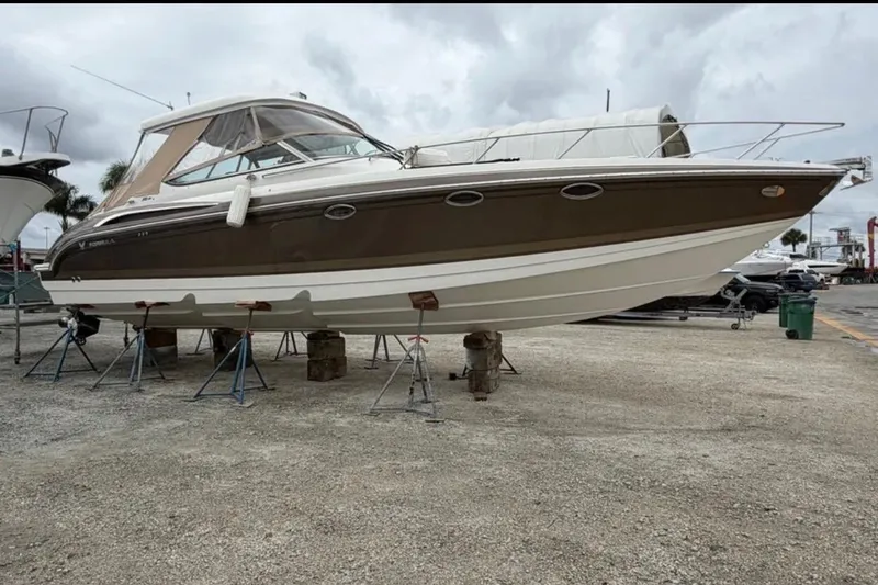 The Image of 2015 Formula 370 Super Sport boat on stands, displayed outdoors. - 0