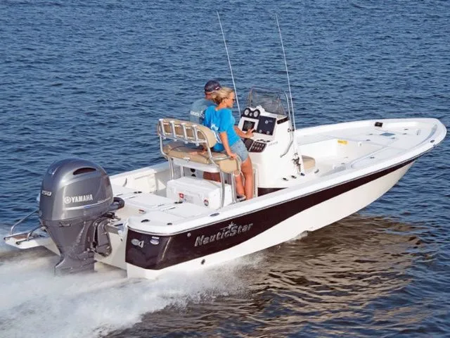 The Image of 2019 NauticStar 215 XTS boat cruising on water. - 1
