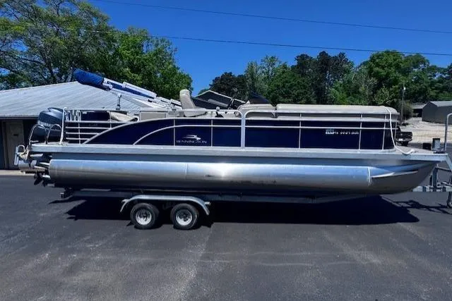 Slide: The Image of 2015 Bennington 2275 GS pontoon boat on trailer, parked outdoors. - 14