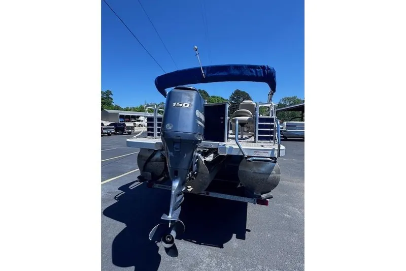 Slide: The Image of 2015 Bennington 2275 GS pontoon boat with Yamaha 150 engine, parked outdoors. - 15