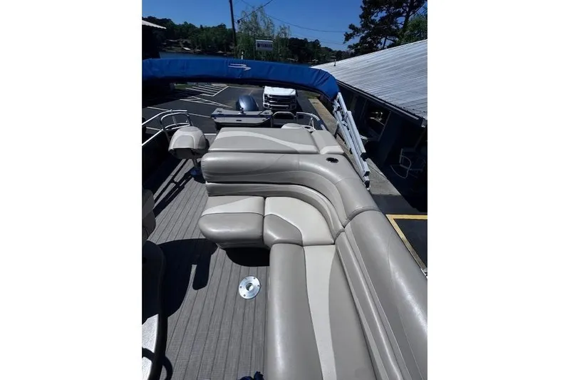 Slide: The Image of 2015 Bennington 2275 GS pontoon boat with beige seating and blue canopy. - 3