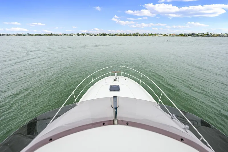 Slide: The Image of 2018 Beneteau Swift Trawler 30 cruising on calm waters under a clear sky. - 14