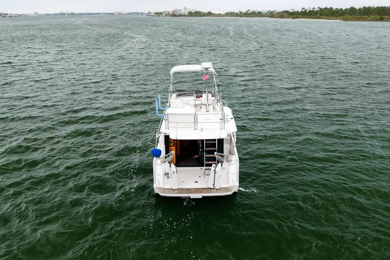 Slide: The Image of 2018 Beneteau Swift Trawler 30 cruising on open water, rear view. - 16