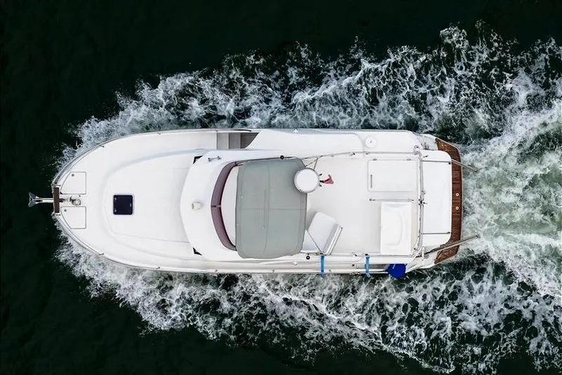 Slide: The Image of Aerial view of 2018 Beneteau Swift Trawler 30 cruising on open water. - 19
