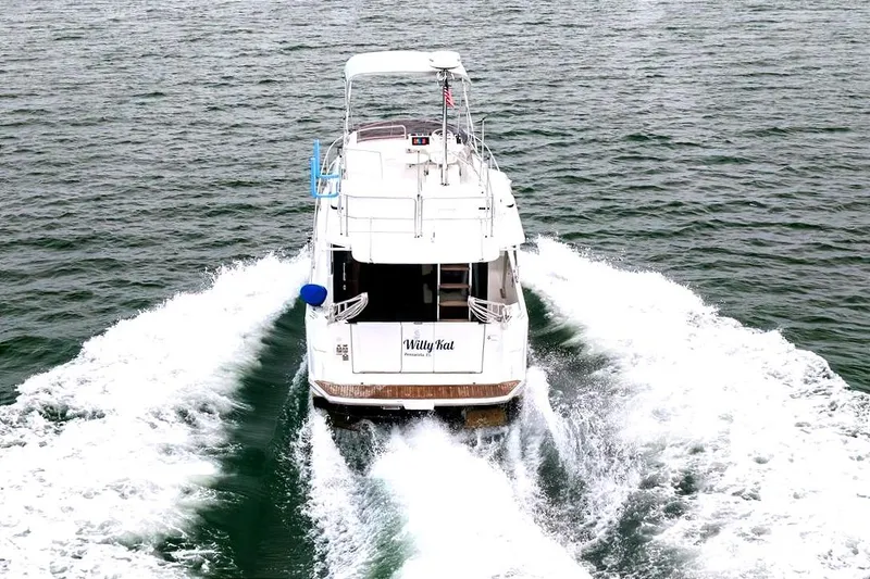 Slide: The Image of 2018 Beneteau Swift Trawler 30 cruising on open water, leaving a wake behind. - 21