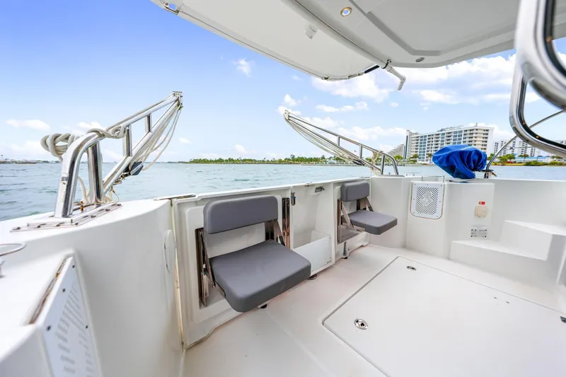 Slide: The Image of 2018 Beneteau Swift Trawler 30 deck with seating, overlooking waterfront and buildings. - 33