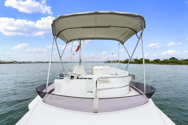 Slide: The Image of 2018 Beneteau Swift Trawler 30 on calm water under a clear blue sky. - 39