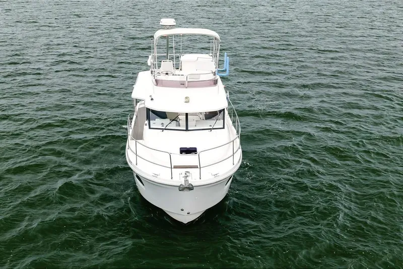 Slide: The Image of 2018 Beneteau Swift Trawler 30 cruising on open water, showcasing sleek design and elegance. - 4