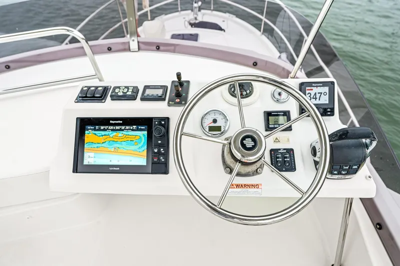 Slide: The Image of Cockpit of 2018 Beneteau Swift Trawler 30 with navigation instruments and steering wheel. - 42