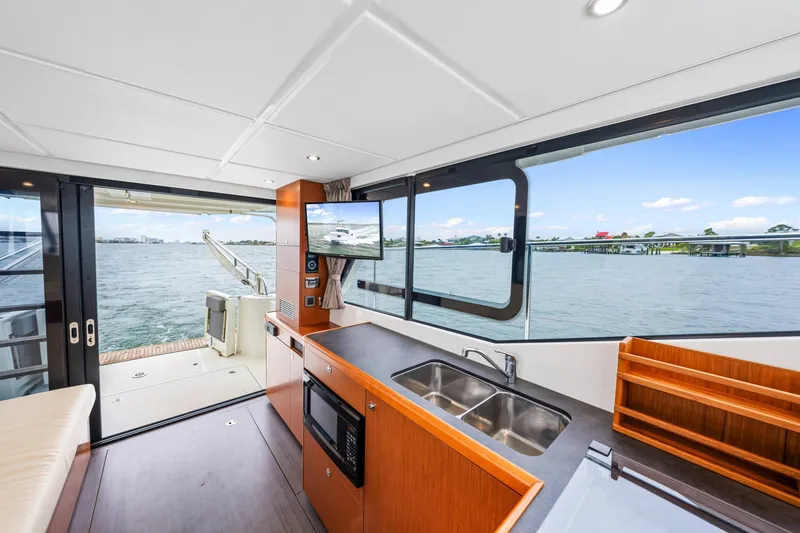 Slide: The Image of Interior of 2018 Beneteau Swift Trawler 30 with modern kitchen and scenic water view. - 46
