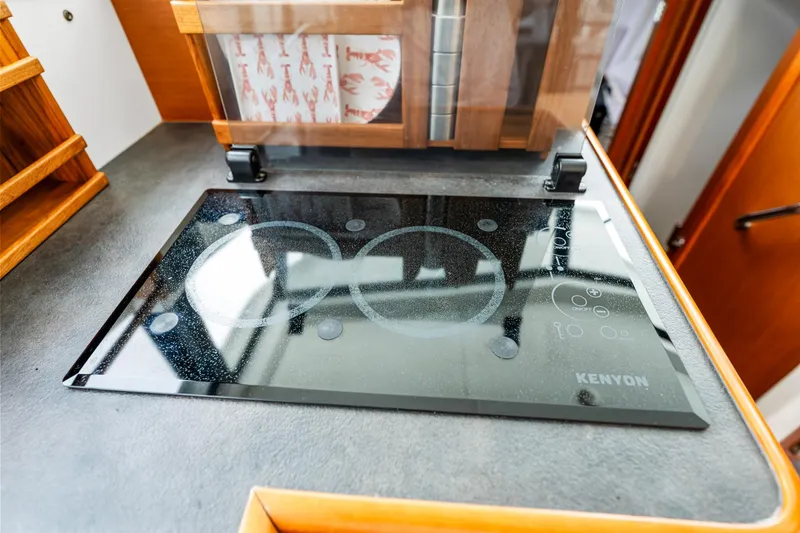 Slide: The Image of Modern Kenyon cooktop in 2018 Beneteau Swift Trawler 30 kitchen area. - 48