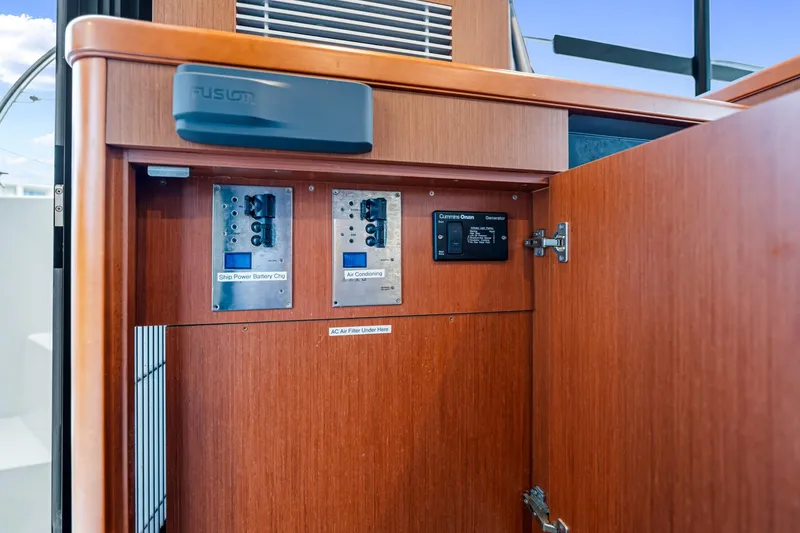 Slide: The Image of Control panel inside 2018 Beneteau Swift Trawler 30, featuring power and air conditioning systems. - 52