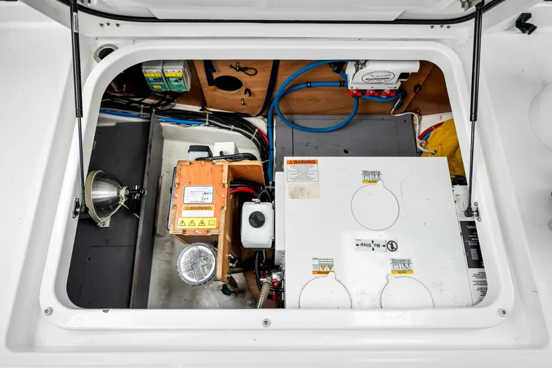 Slide: The Image of Engine compartment of a 2018 Beneteau Swift Trawler 30, showcasing mechanical components and wiring. - 53