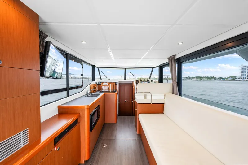 Slide: The Image of Interior of 2018 Beneteau Swift Trawler 30 with modern furnishings and panoramic windows. - 56