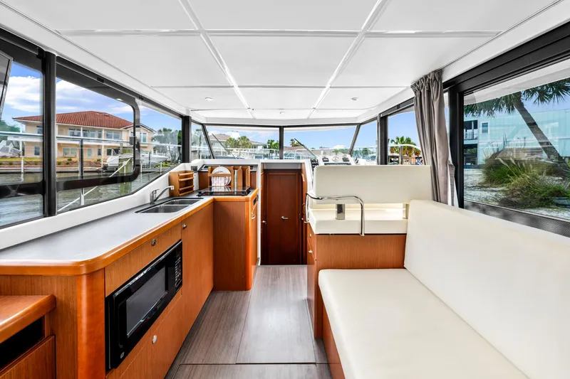Slide: The Image of Interior of 2018 Beneteau Swift Trawler 30, featuring modern kitchen and seating area. - 58