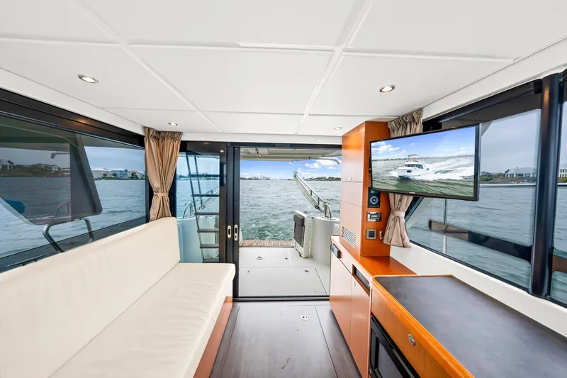 Slide: The Image of Interior of 2018 Beneteau Swift Trawler 30 with modern amenities and scenic water view. - 59