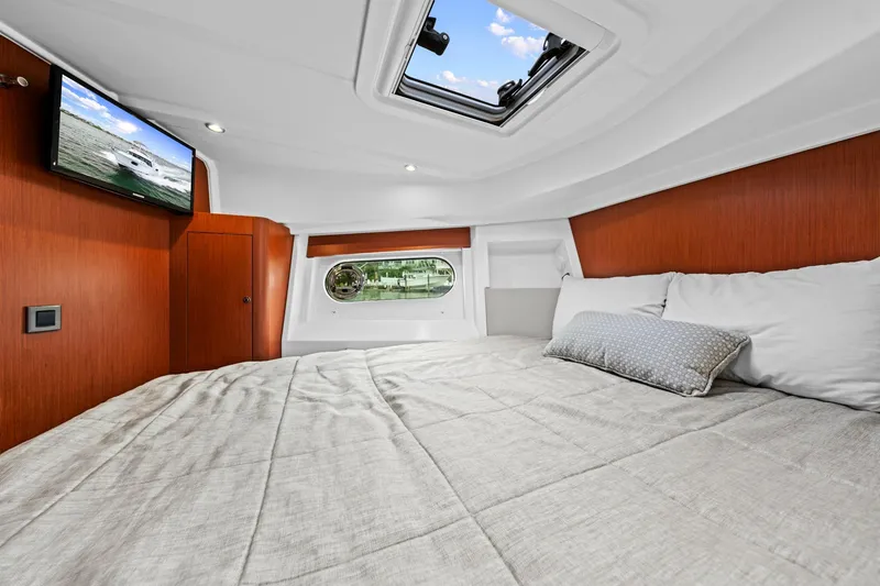 Slide: The Image of Luxurious cabin interior of 2018 Beneteau Swift Trawler 30 with skylight and TV. - 60