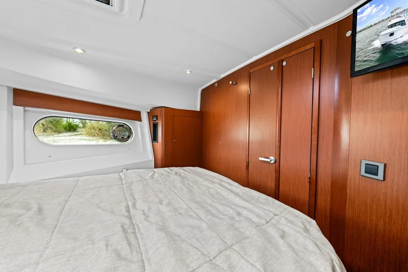 Slide: The Image of Cozy cabin interior of 2018 Beneteau Swift Trawler 30 with wood paneling and window view. - 61
