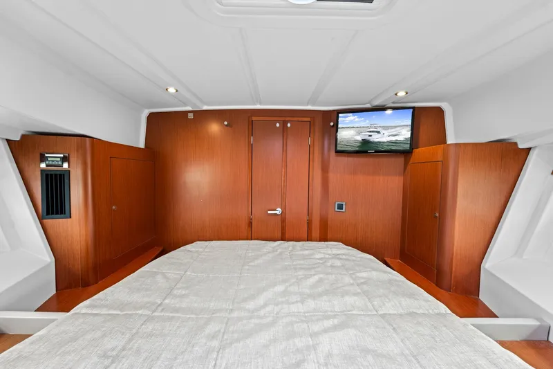 Slide: The Image of 2018 Beneteau Swift Trawler 30 cabin interior with wood paneling and mounted TV. - 62