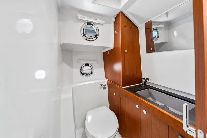 Slide: The Image of 2018 Beneteau Swift Trawler 30 bathroom with wood cabinetry and modern fixtures. - 67