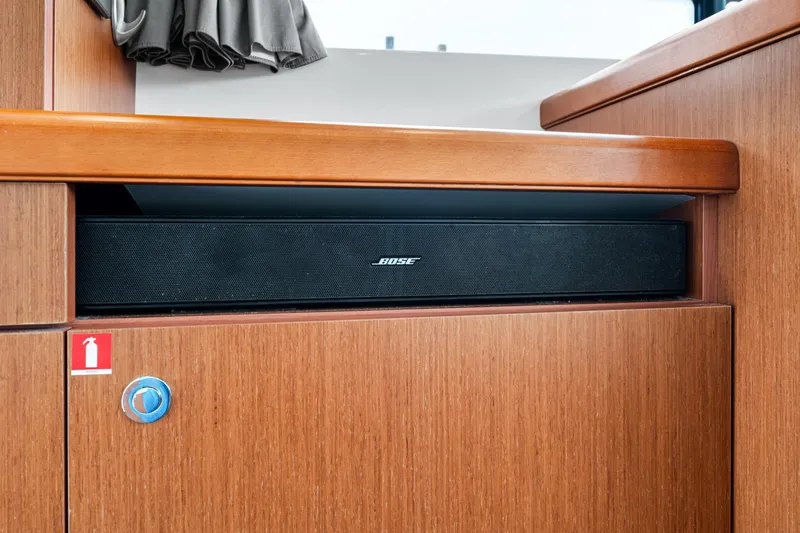 Slide: The Image of Bose speaker on 2018 Beneteau Swift Trawler 30, wooden interior detail. - 68