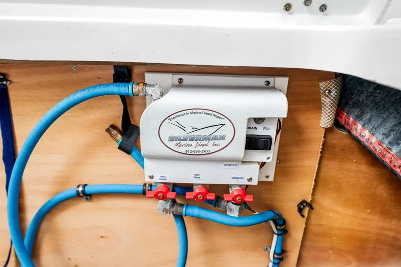 Slide: The Image of Marine diesel repair system on 2018 Beneteau Swift Trawler 30, featuring blue hoses and control panel. - 69