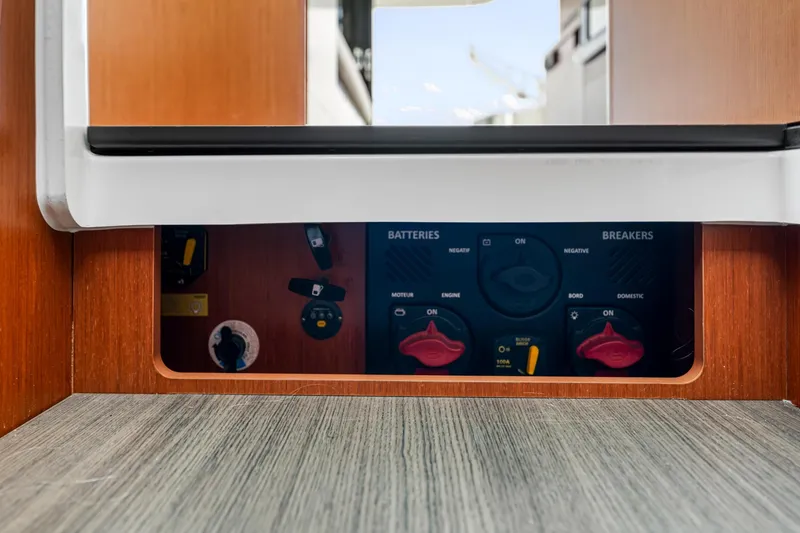 Slide: The Image of Control panel of a 2018 Beneteau Swift Trawler 30, featuring battery and breaker switches. - 70